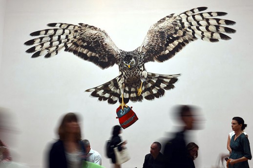 Visitors look at a Jeremy Deller's installation